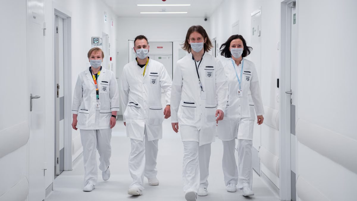 Medical team walking confidently in a hospital corridor, wearing face masks and white coats, symbolizing teamwork and healthcare dedication.